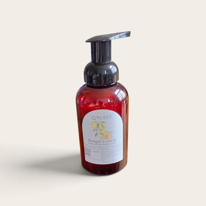 Bougie Lemon foaming hand soap in an amber bottle with a black pump against a textured cream background.