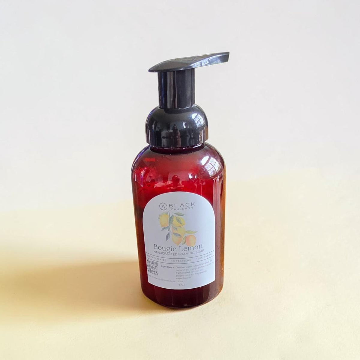 Bougie Lemon foaming hand soap in an amber bottle with a black pump against a textured cream background.