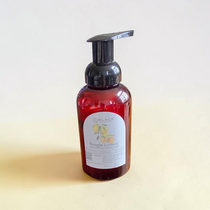 Bougie Lemon foaming hand soap in an amber bottle with a black pump against a textured cream background.