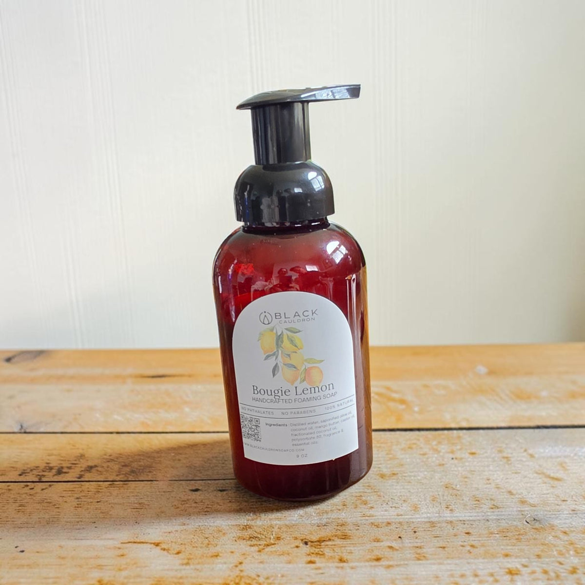 Bougie Lemon foaming hand soap in an amber bottle with a black pump against a textured cream background.