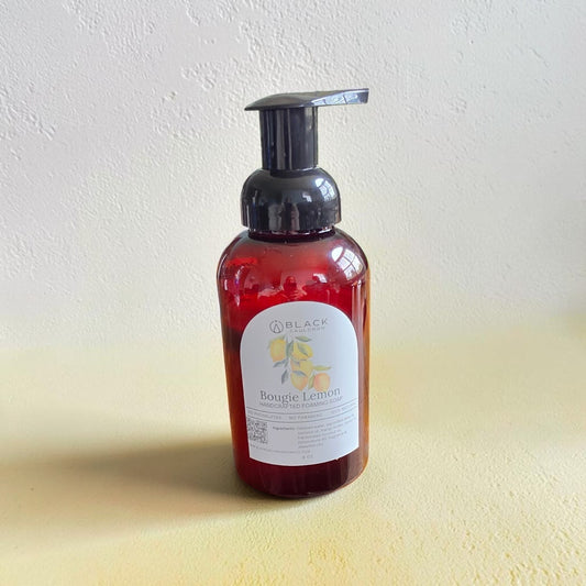 Bougie Lemon foaming hand soap in an amber bottle with a black pump against a textured cream background.