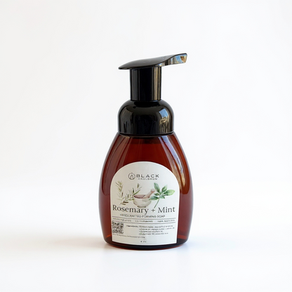 Foaming handsoap scented rosemary mint in an amber bottle with black pump.